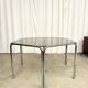 Vintage hexagonal table with smoked glass top and chrome metal structure.