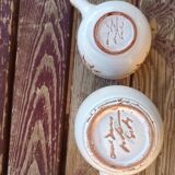 2 beige ceramic pots painted with signature