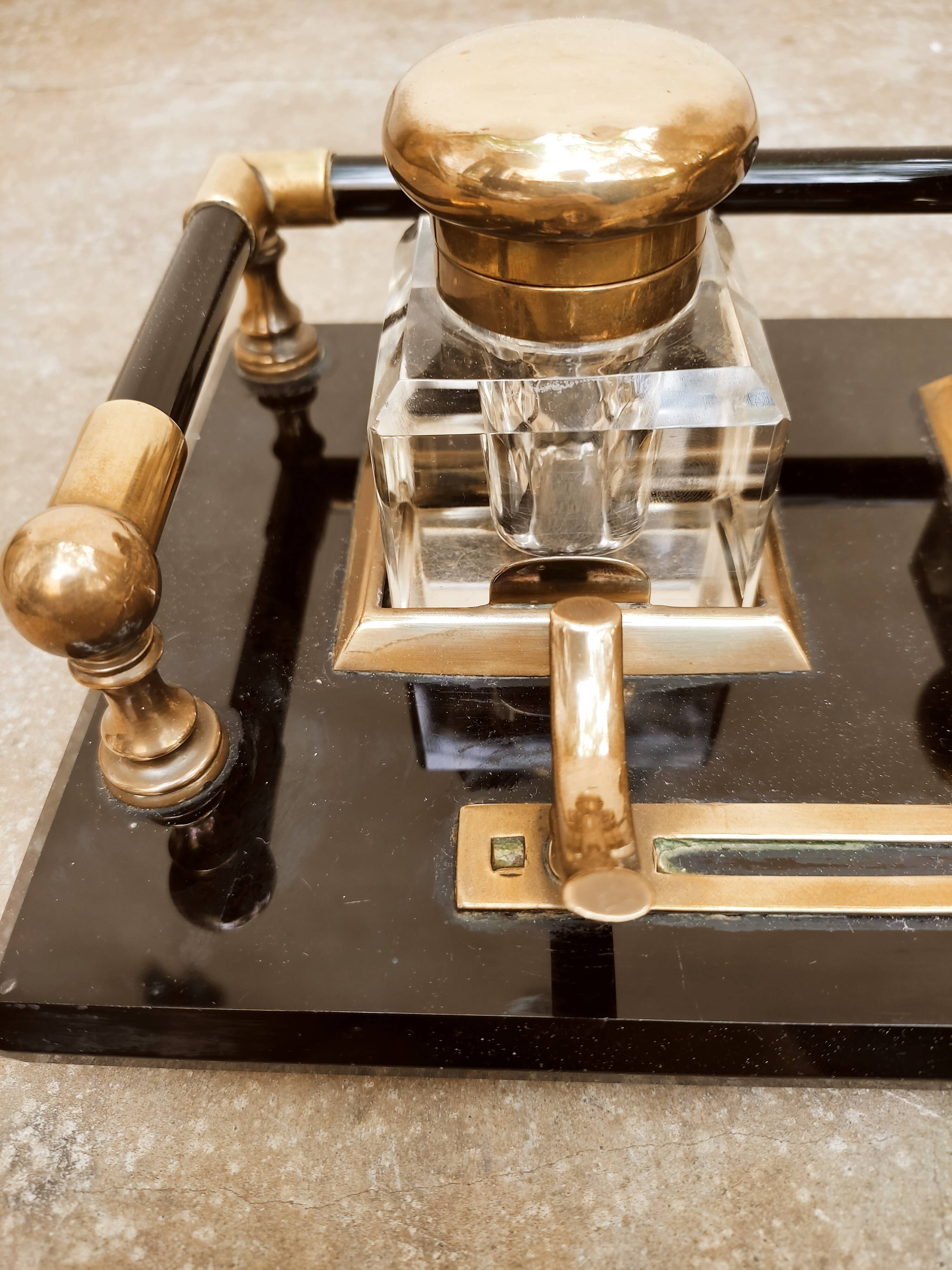 Hence the art deco inkwell on jet plate brass finishes