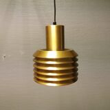 Hanging lamp in gold-colored aluminum with many layers of shades.