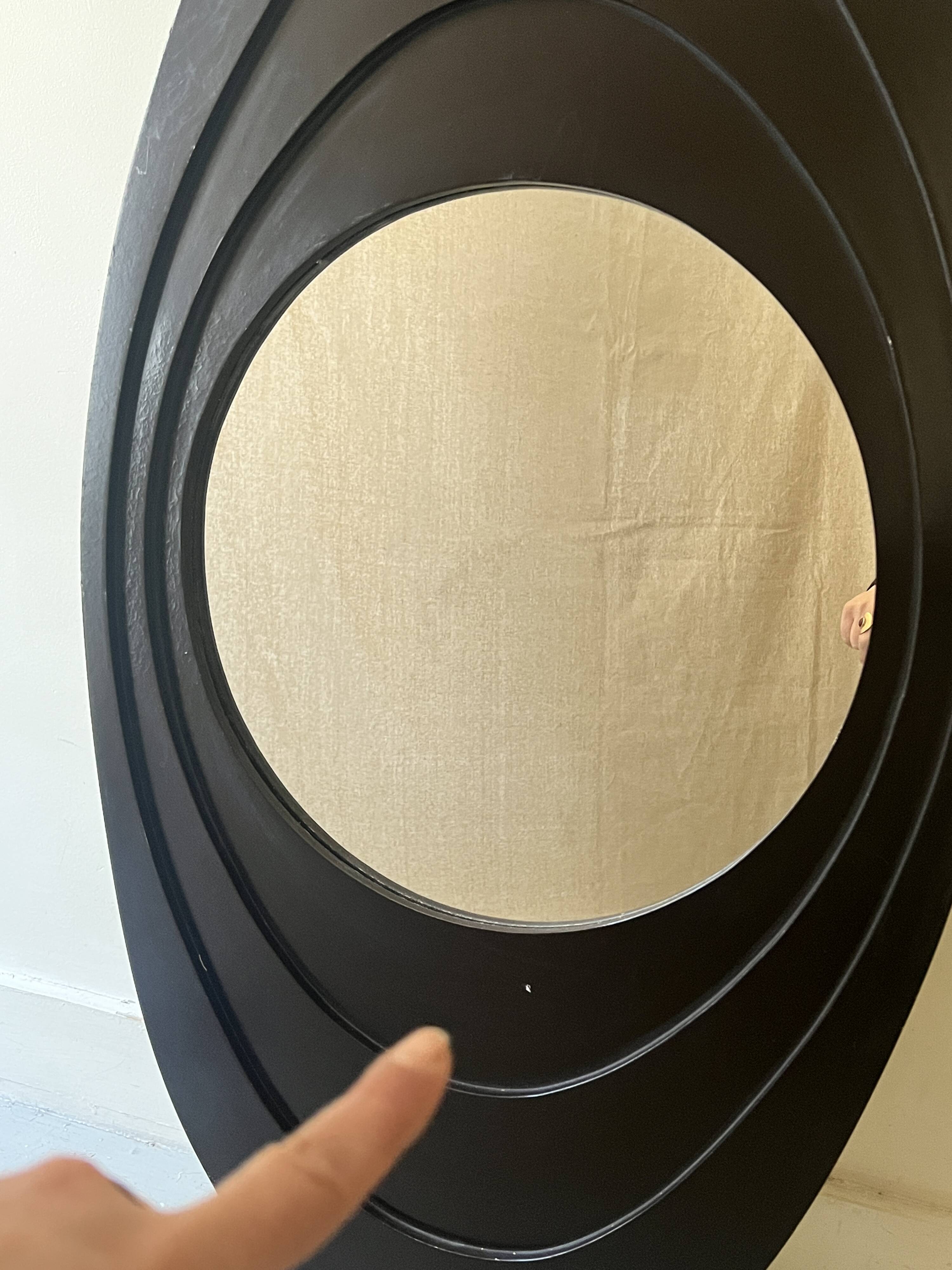 Large oval Italian mirror, modernist, space age design from the 1970s.