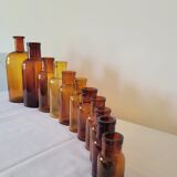 11 bottles of amber glass apothecary