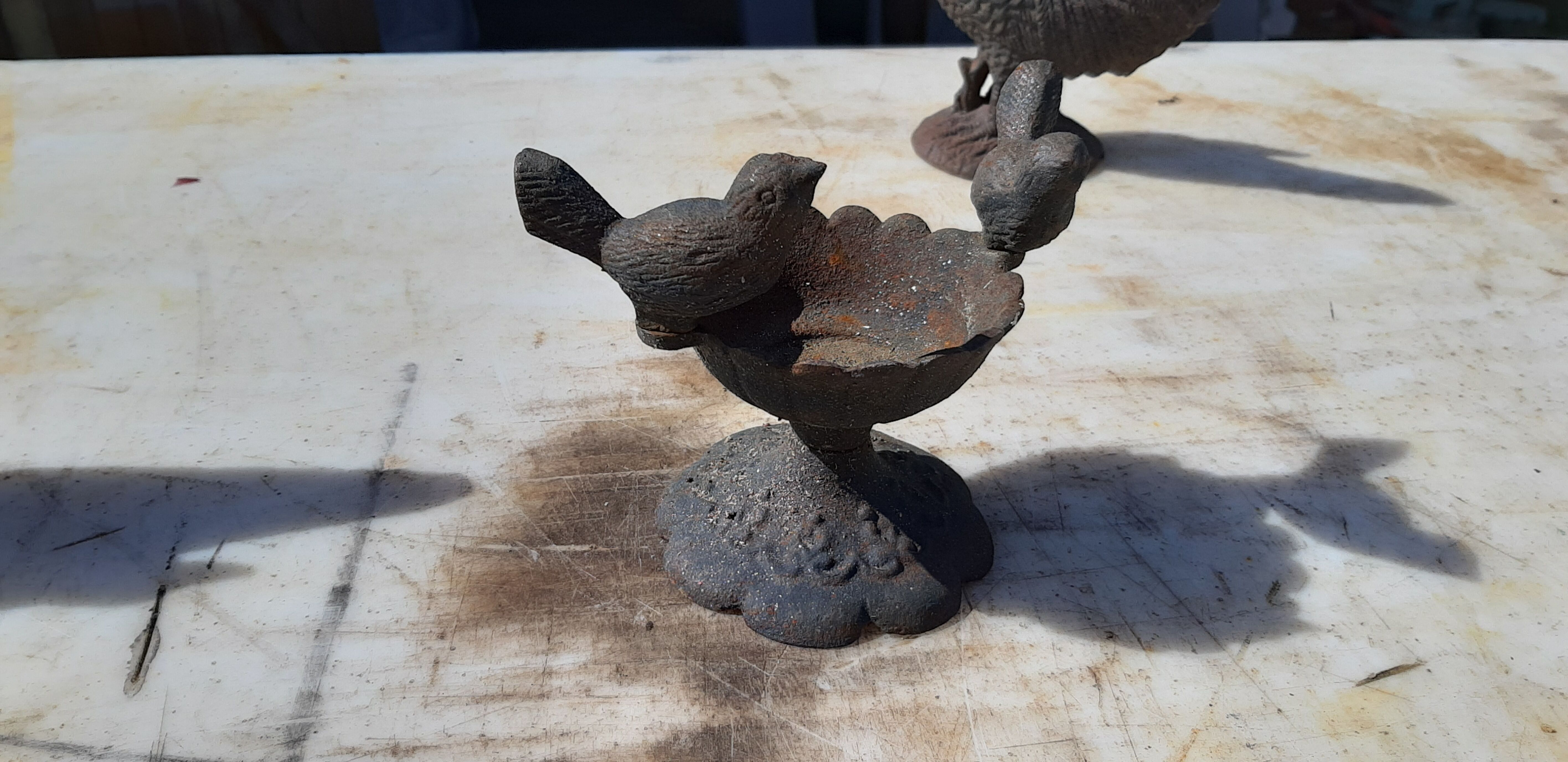 2 roosters and 2 cast iron birds
