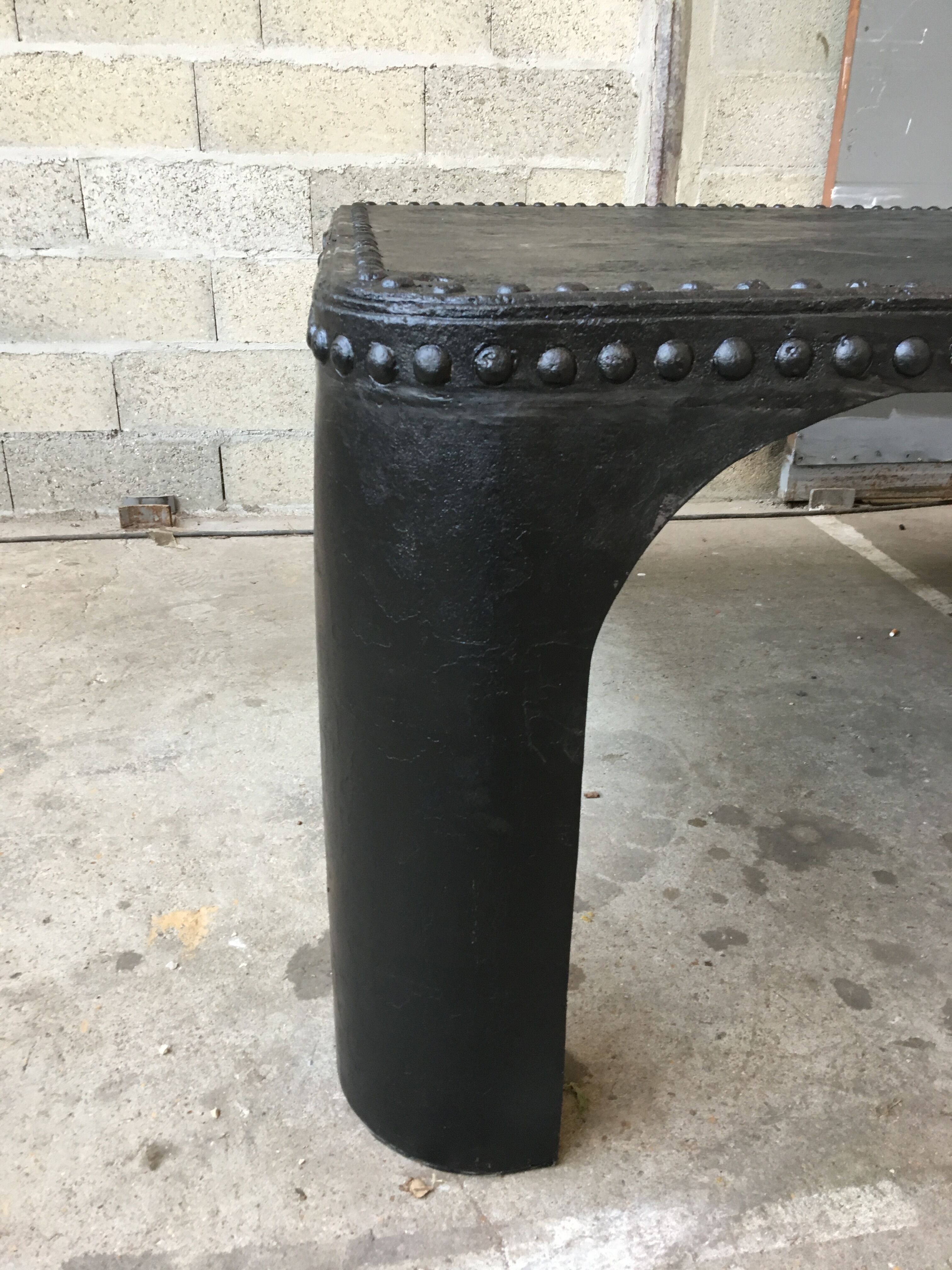 large industrial table in graphite black riveted metal