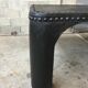 large industrial table in graphite black riveted metal