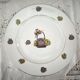 Round porcelain plate from Limoges with a hydrangea basket design.