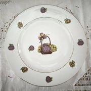 Round porcelain plate from Limoges with a hydrangea basket design.