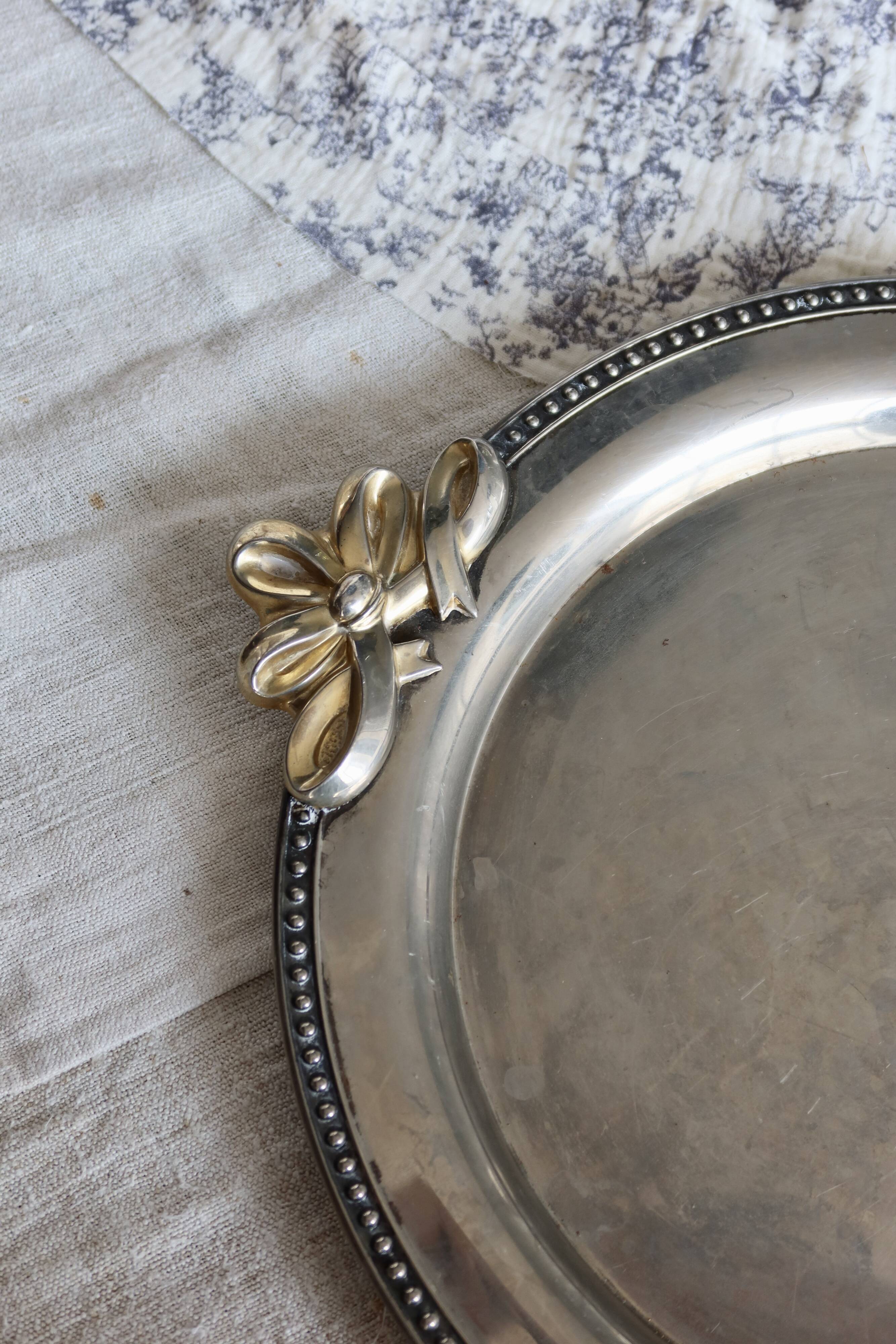 Vintage round silver metal serving tray with gold knot handles