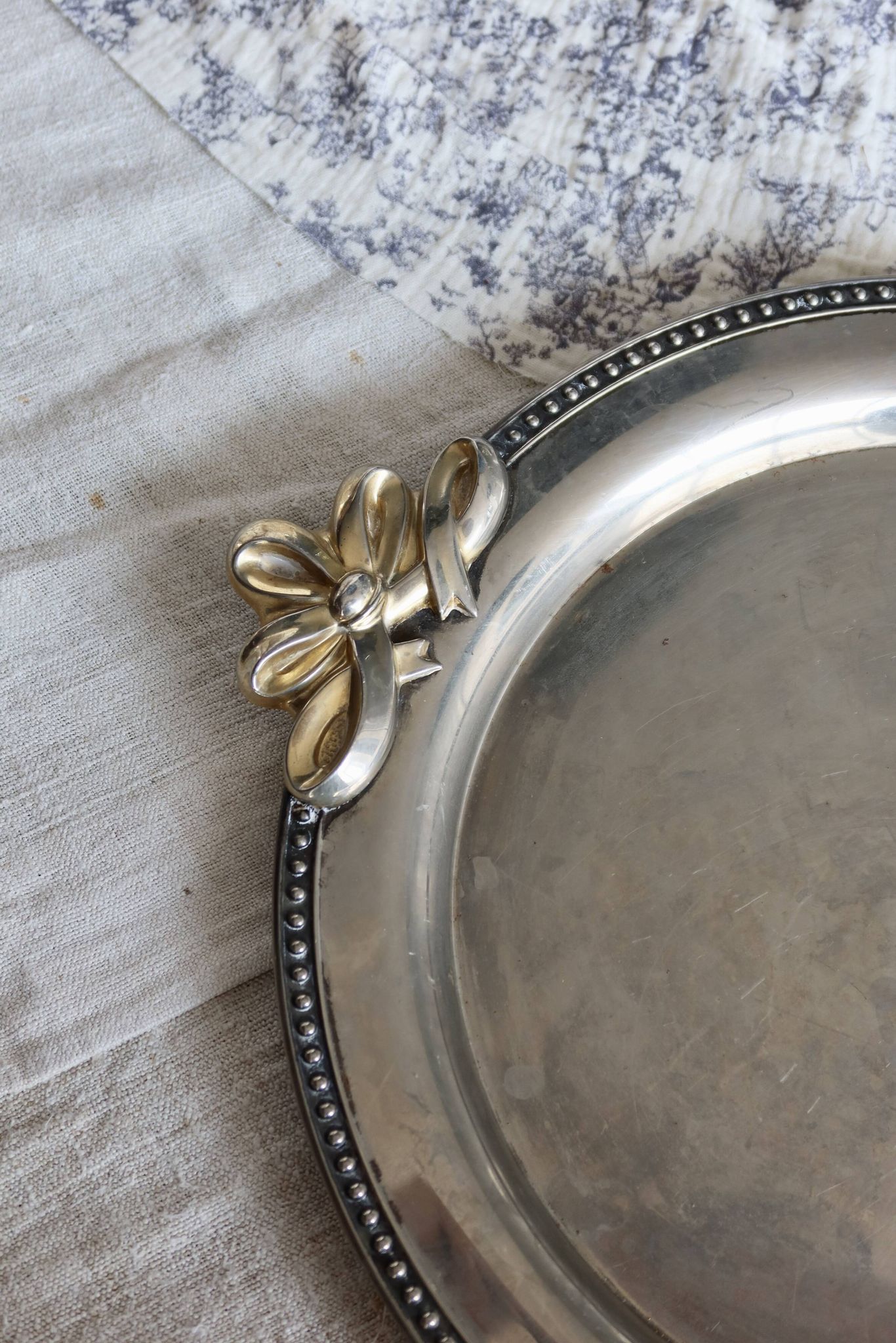 Vintage round silver metal serving tray with gold knot handles