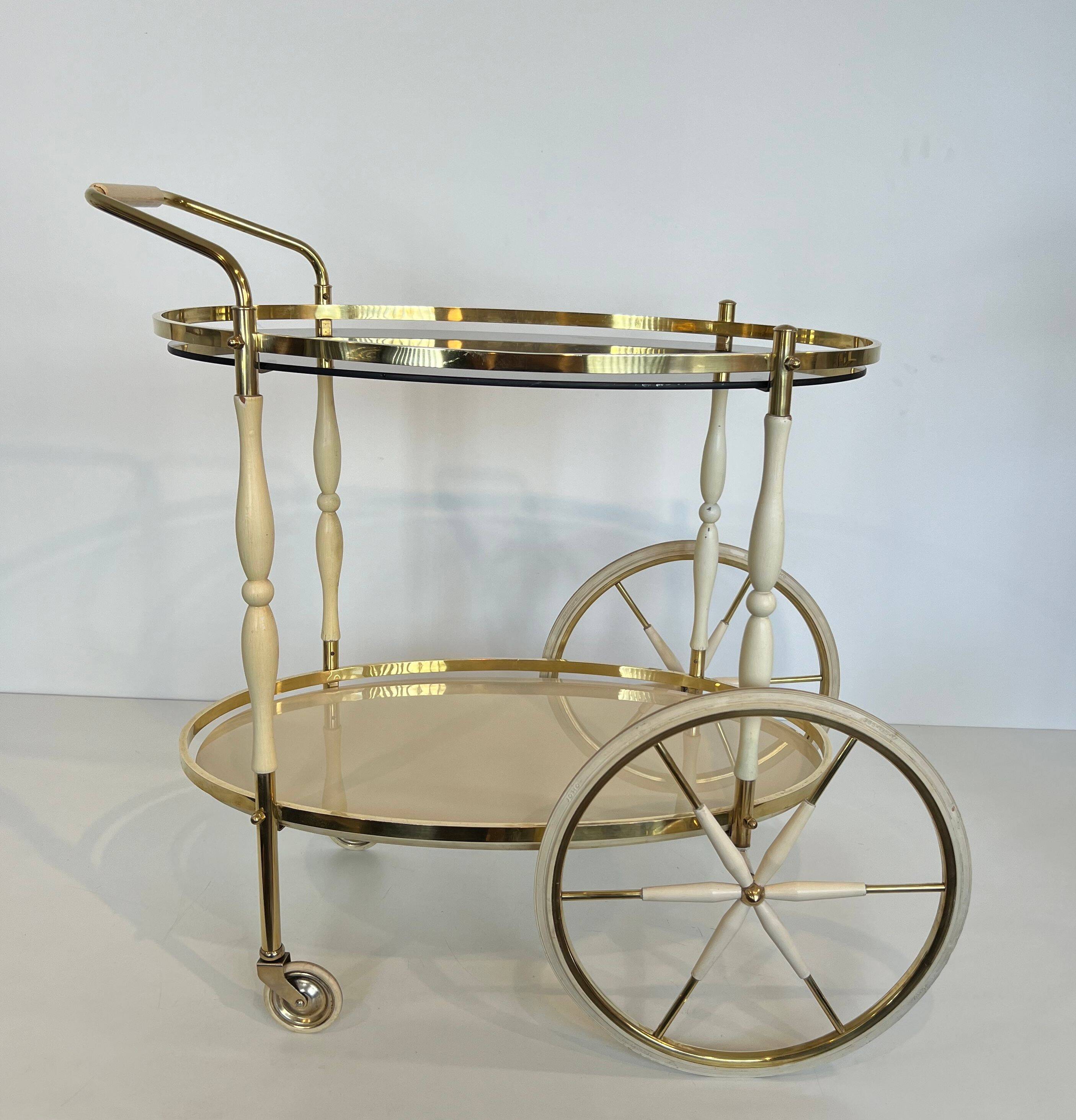 Italian oval rolling table in brass and lacquered wood.