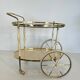 Italian oval rolling table in brass and lacquered wood.