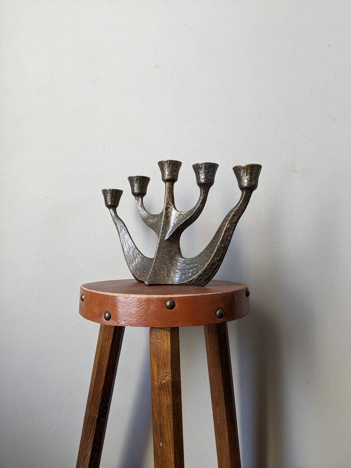 Vintage bronze candlestick chandelier in contemporary Scandinavian design.