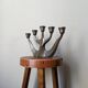 Vintage bronze candlestick chandelier in contemporary Scandinavian design.