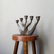 Vintage bronze candlestick chandelier in contemporary Scandinavian design.