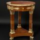Circular gueridon empire of the 19th century in marquetry ornamented with gilt bronze