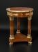 Circular gueridon empire of the 19th century in marquetry ornamented with gilt bronze