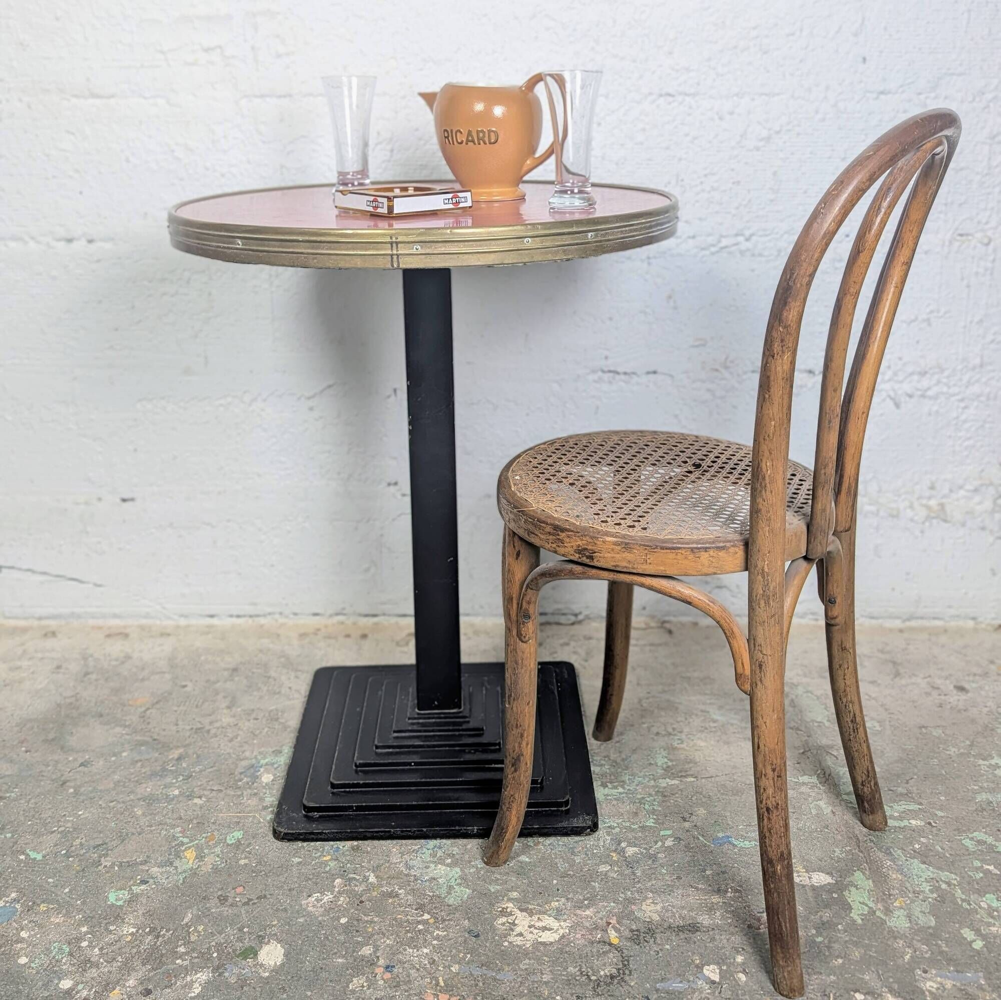 Pink and brass bistro table, Art Deco pyramidal base.