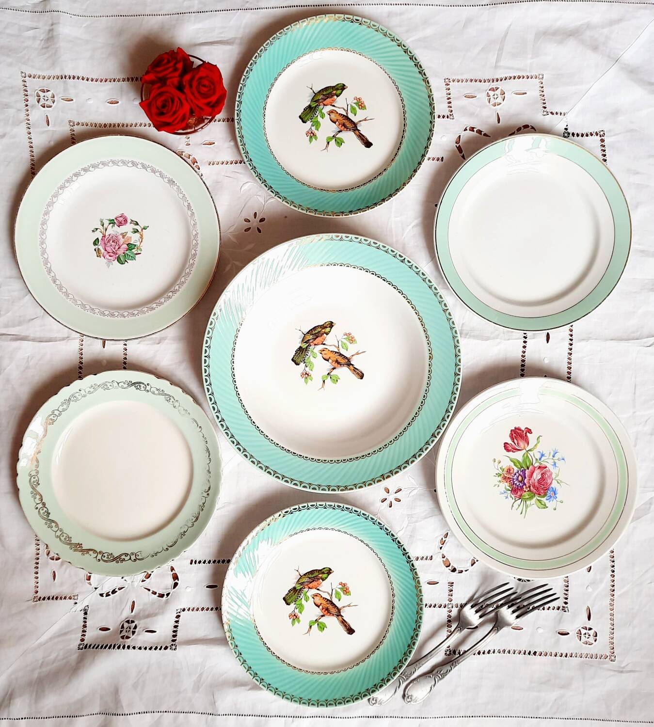 Old mismatched earthenware dinner plates accompanied by a deep dish