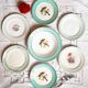 Old mismatched earthenware dinner plates accompanied by a deep dish