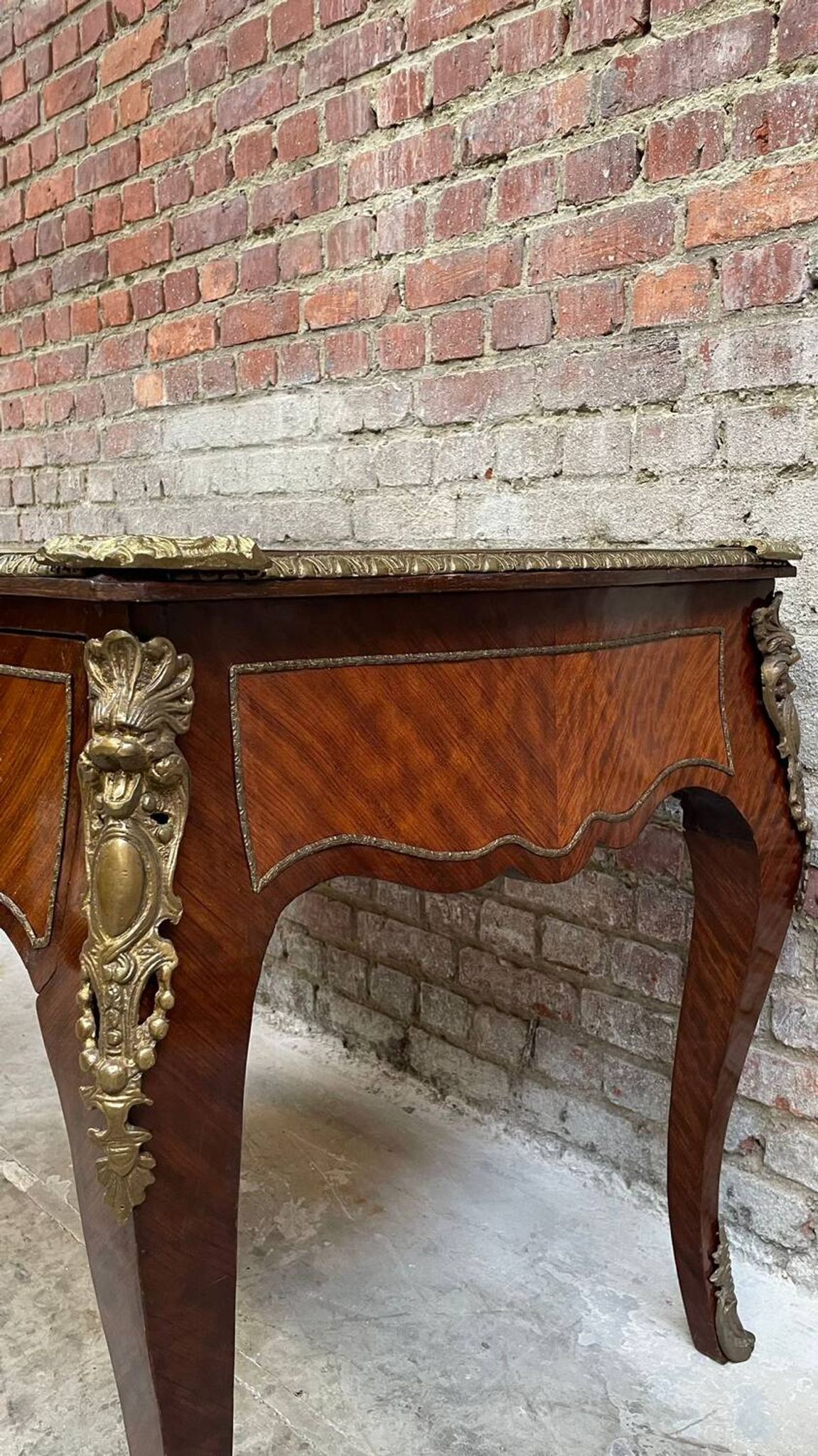 Antique French-style desk with green leather top and bronze mounts
