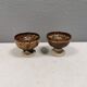 A set of ceramic candle holders in earthy colours.