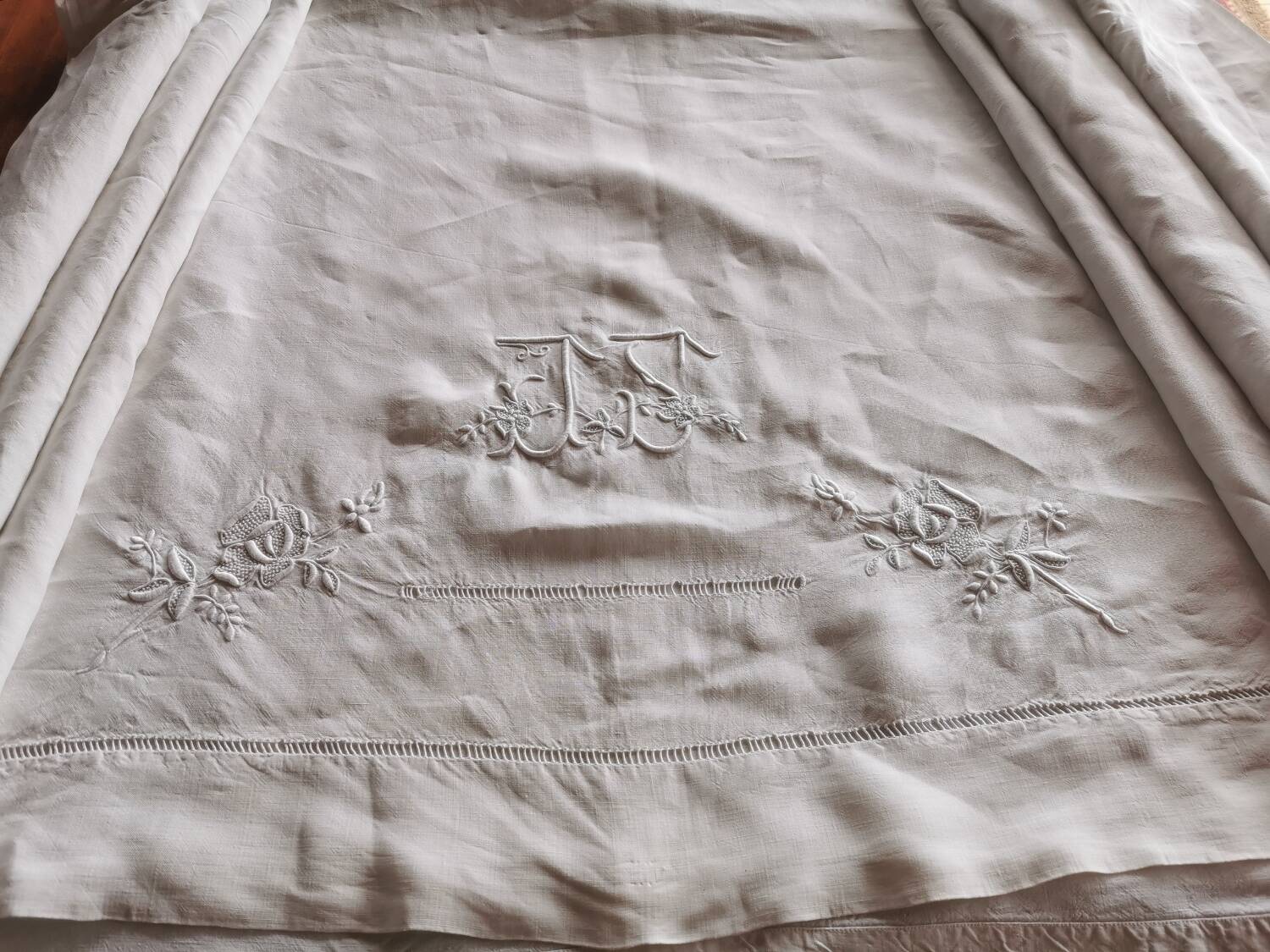 Antique embroidered linen sheet with a monogram.