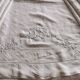 Antique embroidered linen sheet with a monogram.