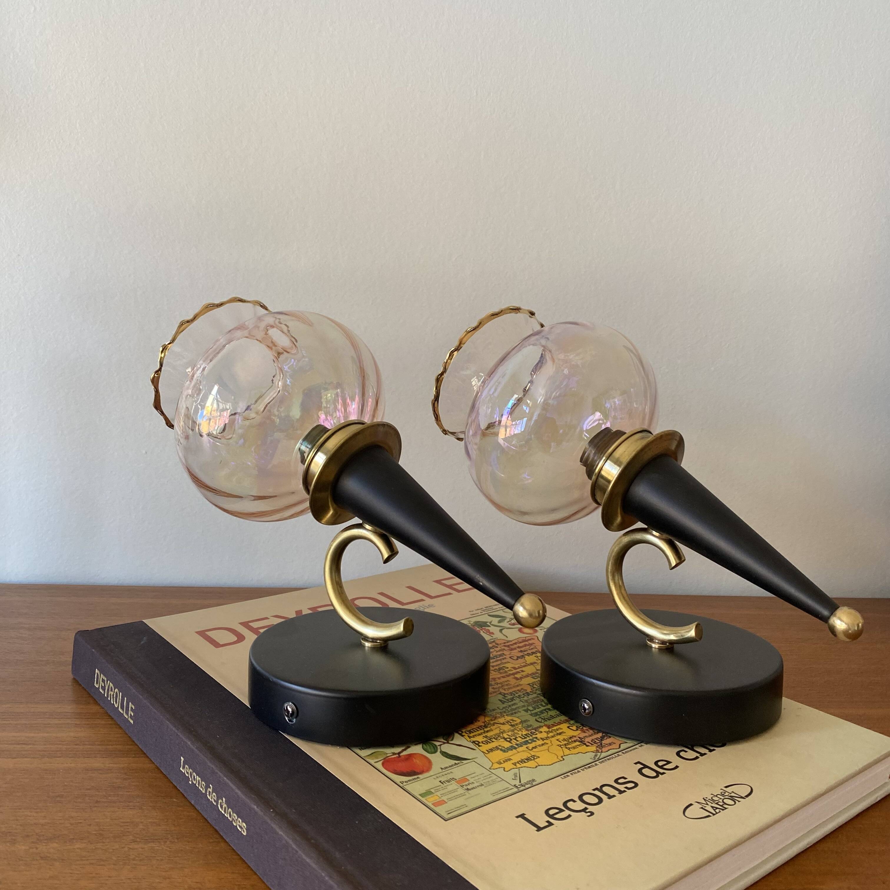 Pair of torch wall lights with iridescent pink glass shades and gold trim.