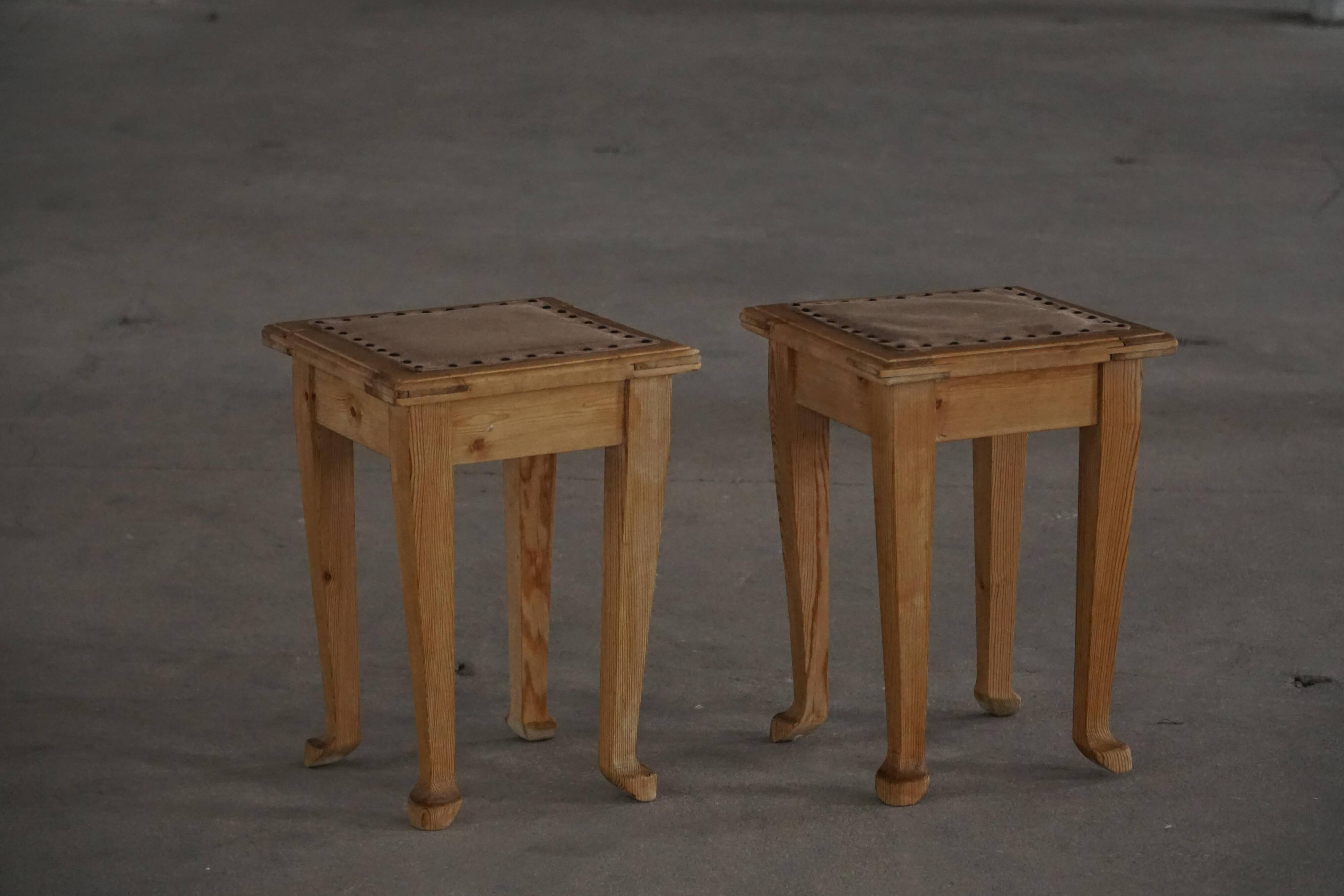 A pair of antique Danish pine stools from the late 19th century.