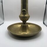 Candle holder with a pusher