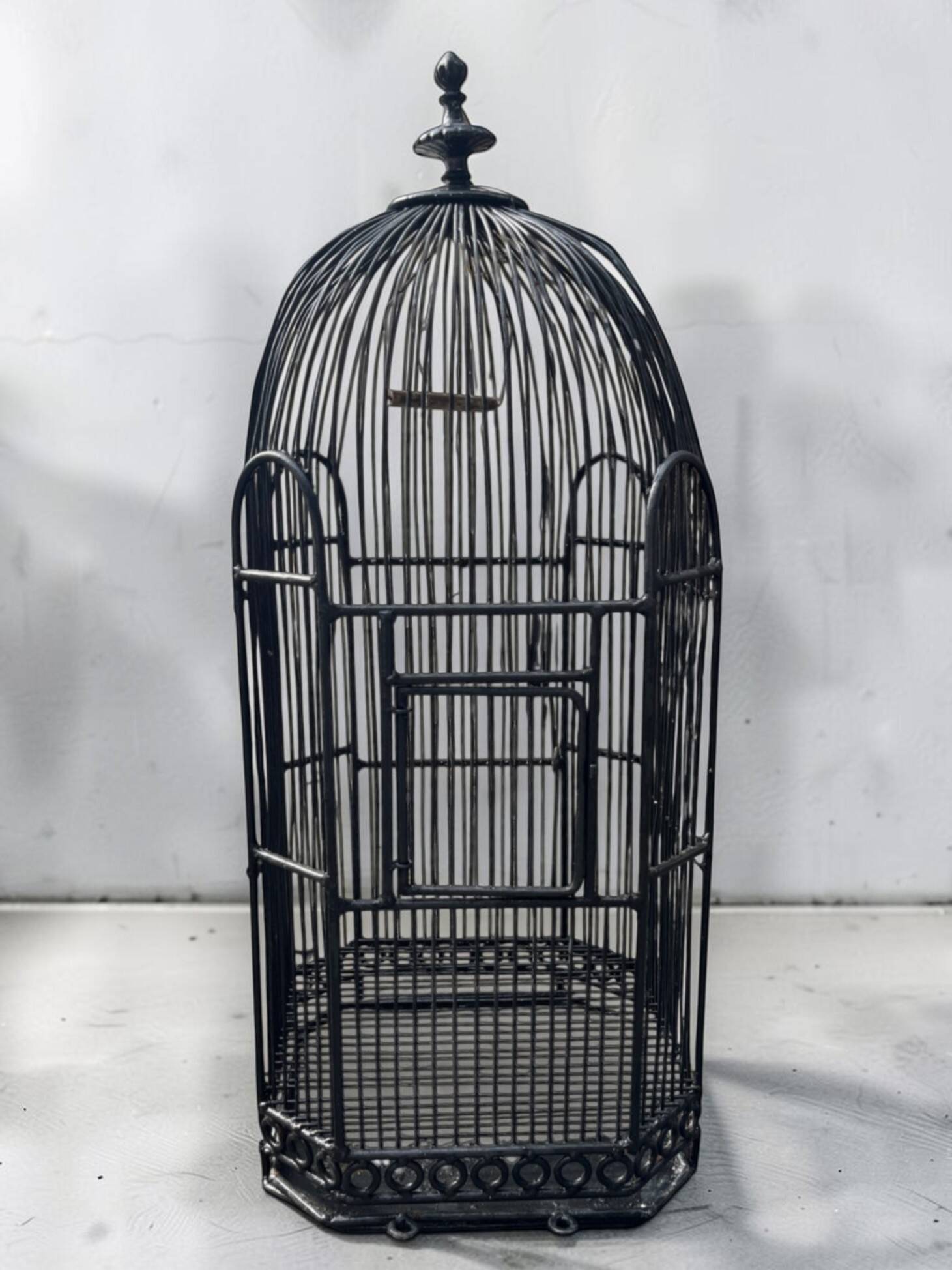 Old black metal birdcage from the early 20th century.