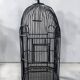 Old black metal birdcage from the early 20th century.