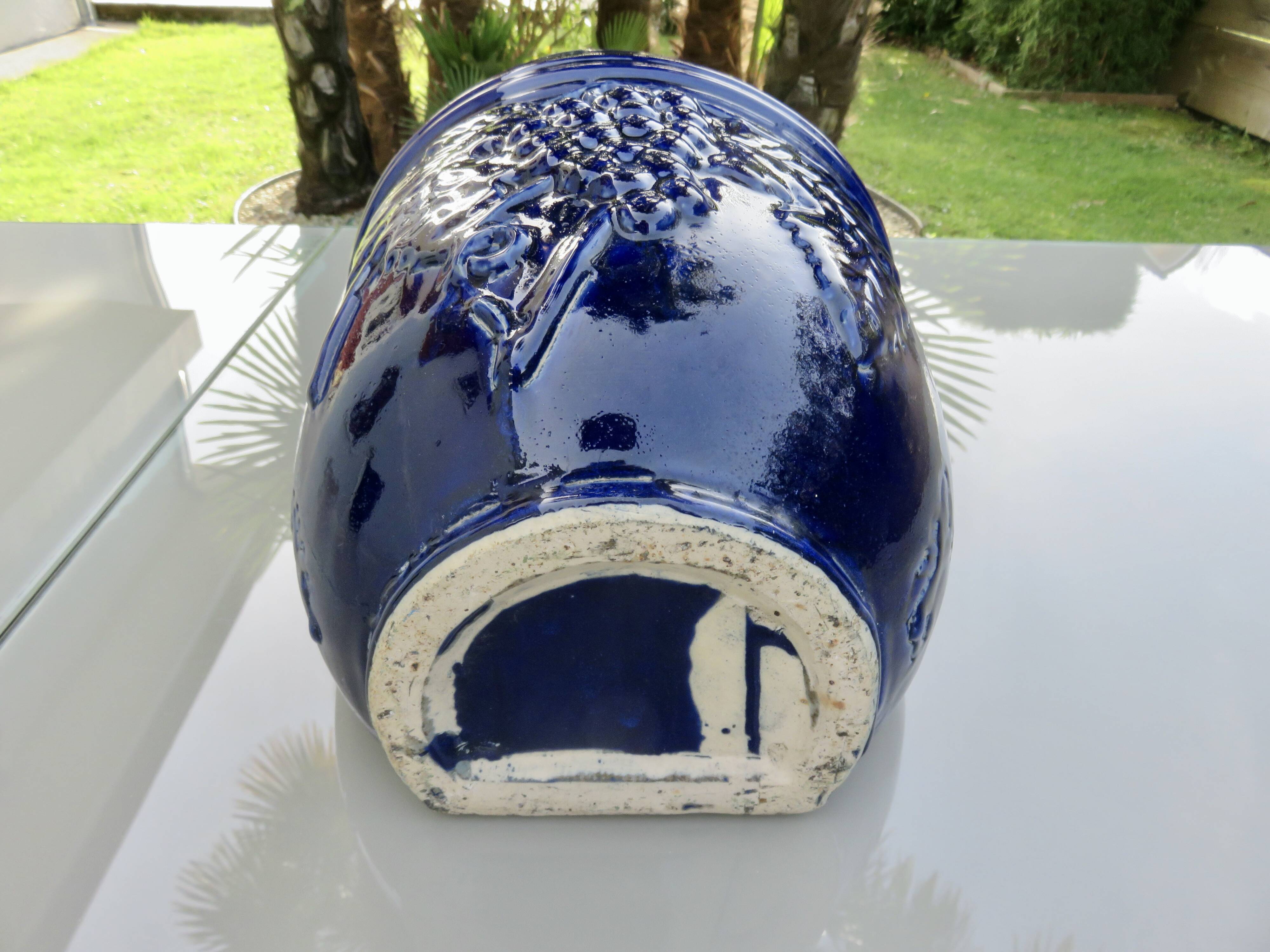 Wall pot in glazed blue terracotta with a grape motif, 1970s.