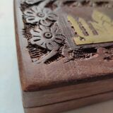 Old wooden box carved with flowers and brass