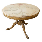 Round marble coffee table with a gold base in classic style.