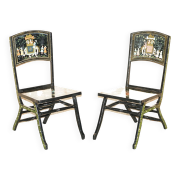 Pair of military folding chairs with Indian decoration.