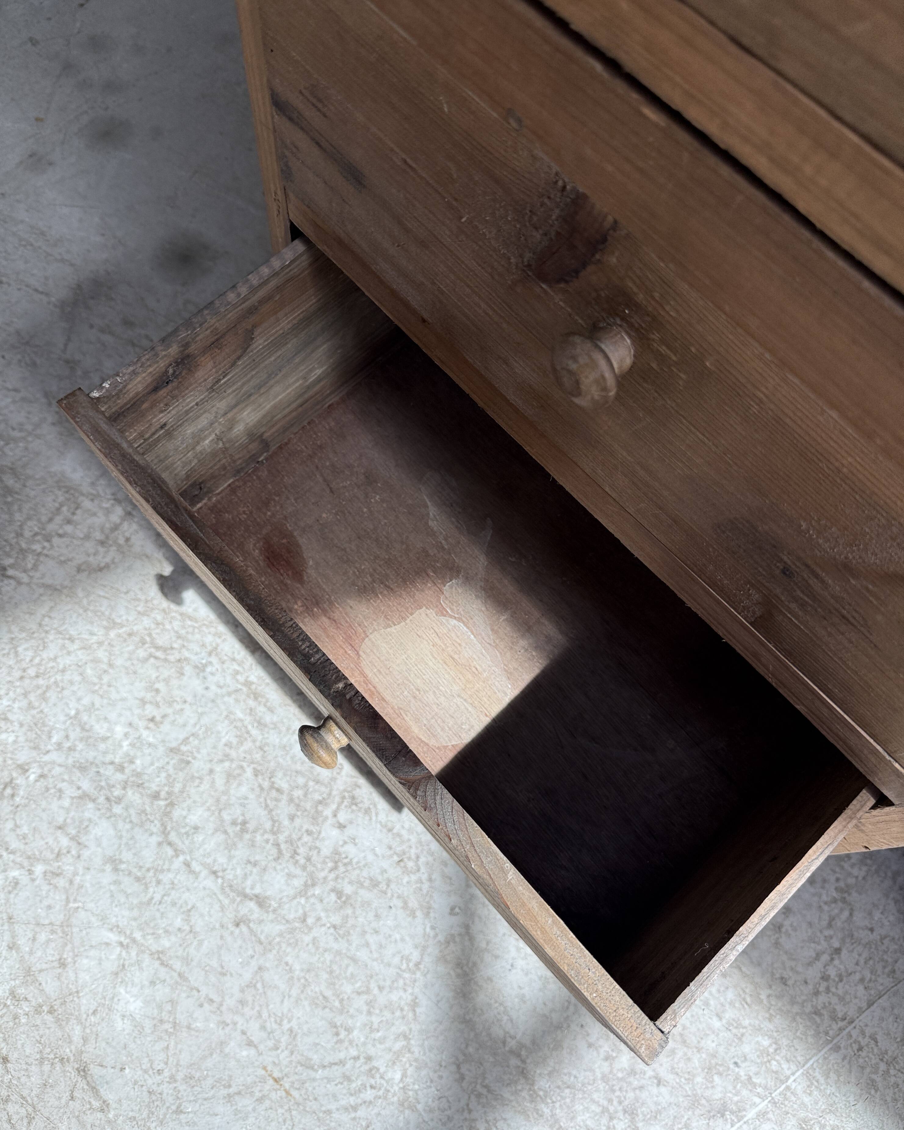 Column storage unit with a sculpted metal door.