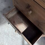 Column storage unit with a sculpted metal door.