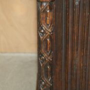 Jacobean hardwood library with carved panels and glass doors.