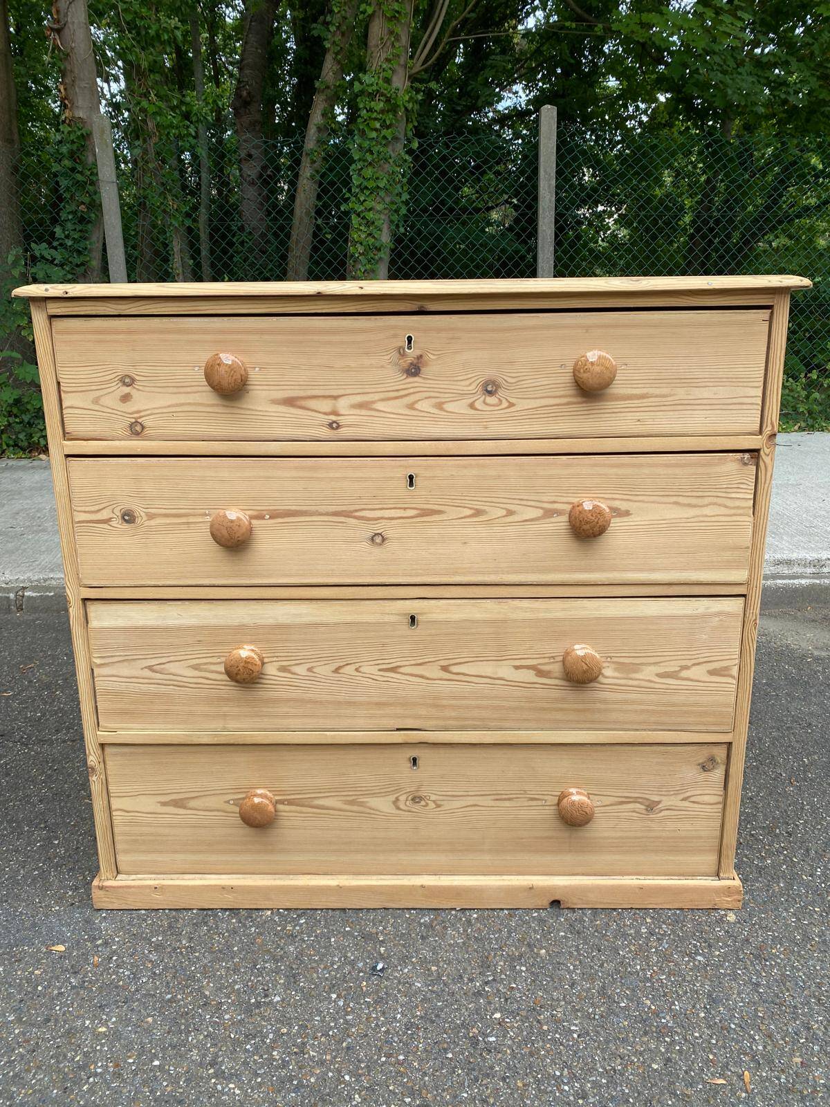 Victorian commode from the 19th century stripped to raw solid wood with ceramic knobs.