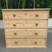 Victorian commode from the 19th century stripped to raw solid wood with ceramic knobs.