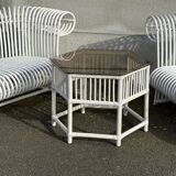 Rattan lounge with two two-seater sofas and a white coffee table.