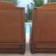 Pair of aged leather armchairs with seat and firm backrest with cherry wood frame