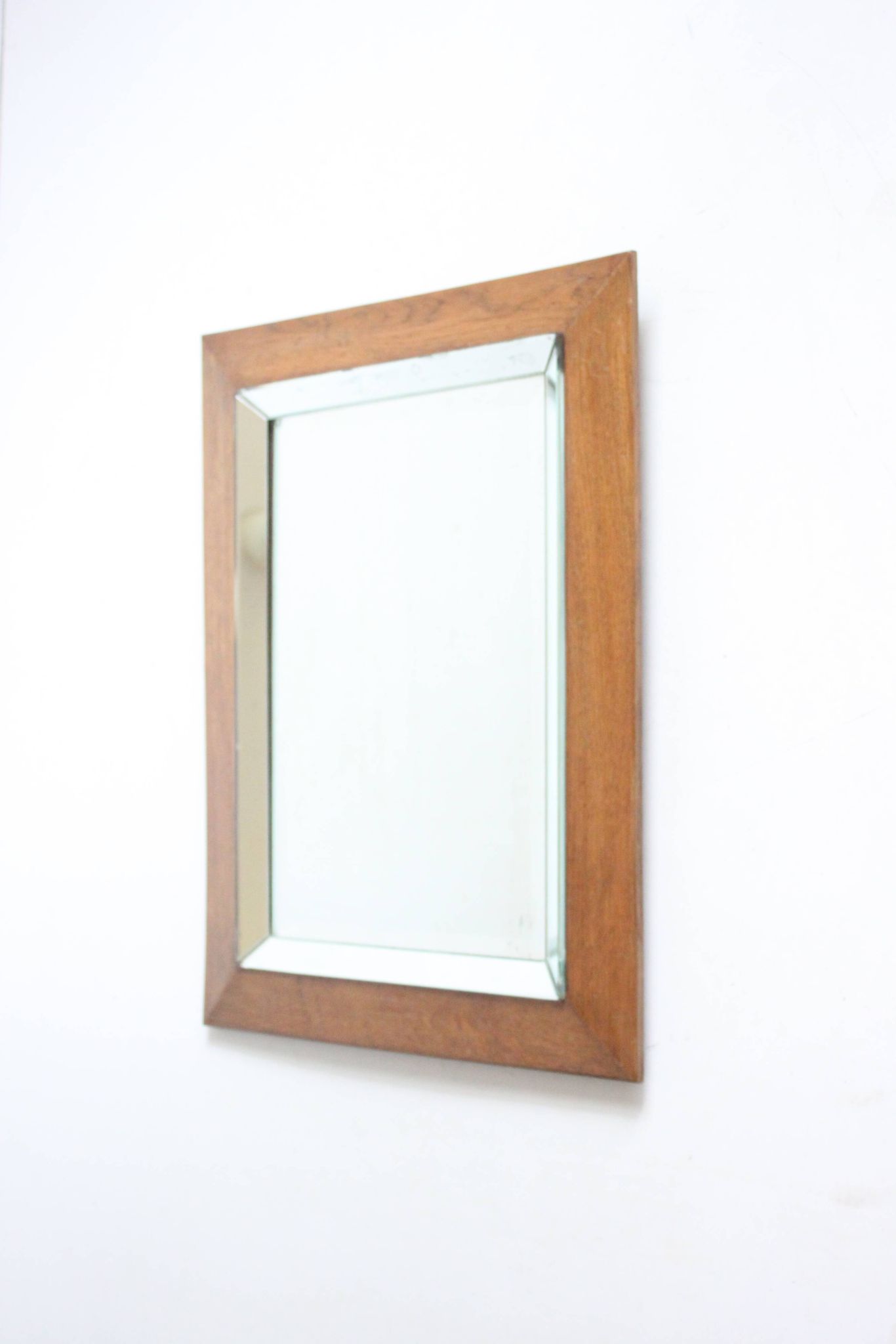 Art deco beveled mirror in an oak frame, 1940s.