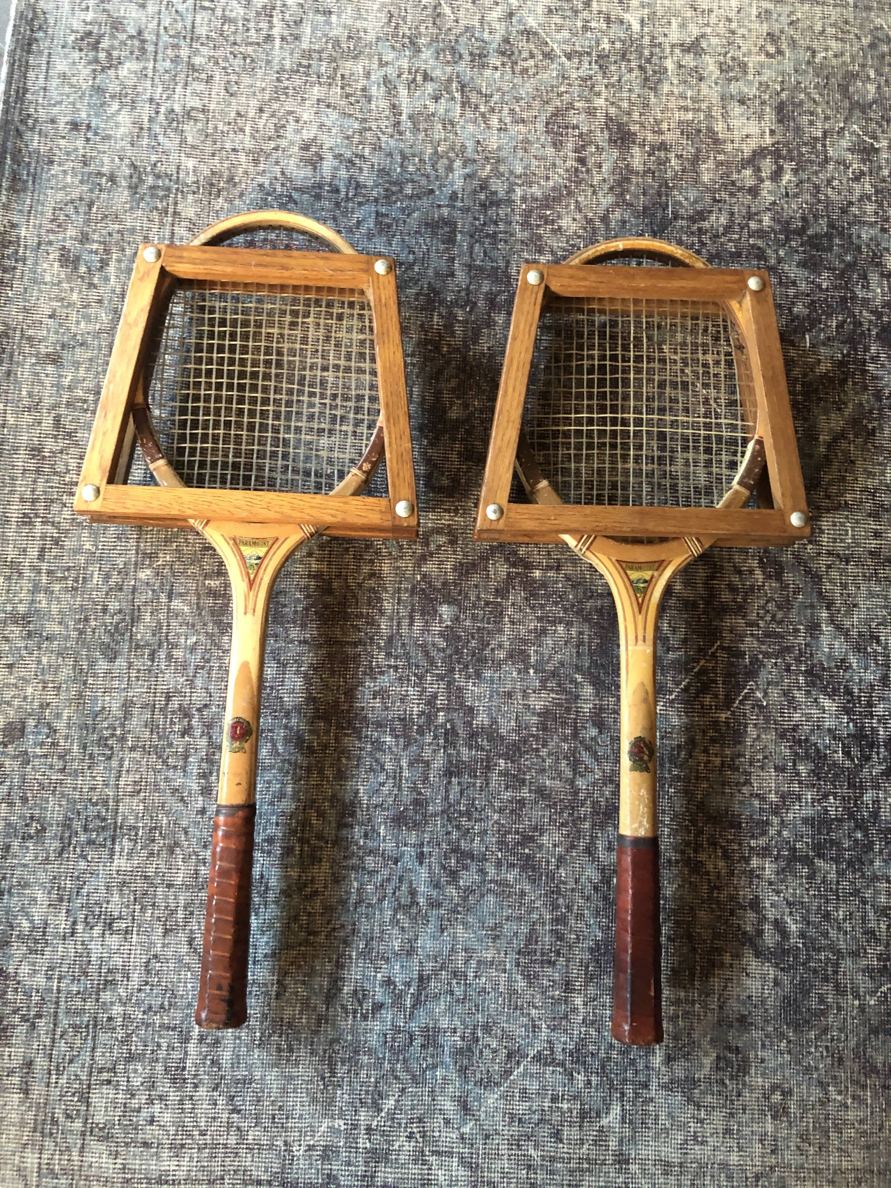 Pair of old wooden tennis rackets with 50s frames