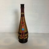 Old bottle in yellow, red and black scoubidou