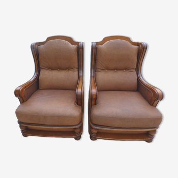 Pair of aged leather armchairs with seat and firm backrest with cherry wood frame