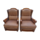 Pair of aged leather armchairs with seat and firm backrest with cherry wood frame