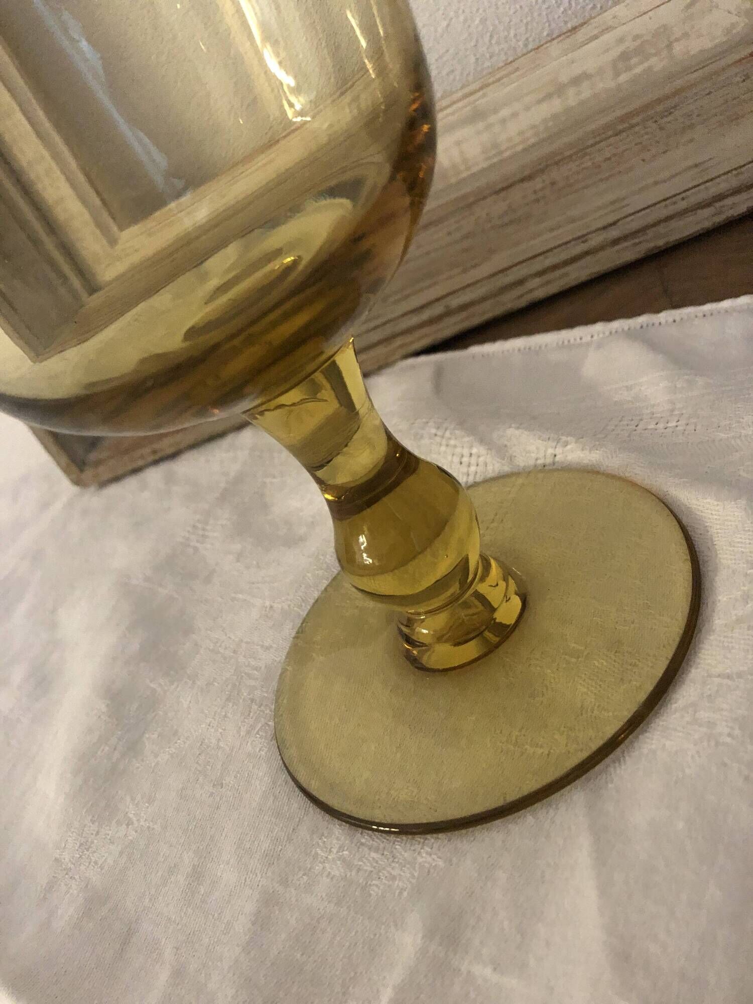 Yellow chalice vase, yellow glass vase on a pedestal.