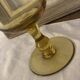 Yellow chalice vase, yellow glass vase on a pedestal.